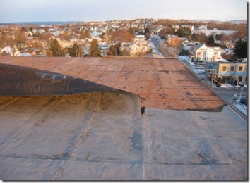 Roof Coatings - Mod-Bit Roof Peeled Back From High Winds